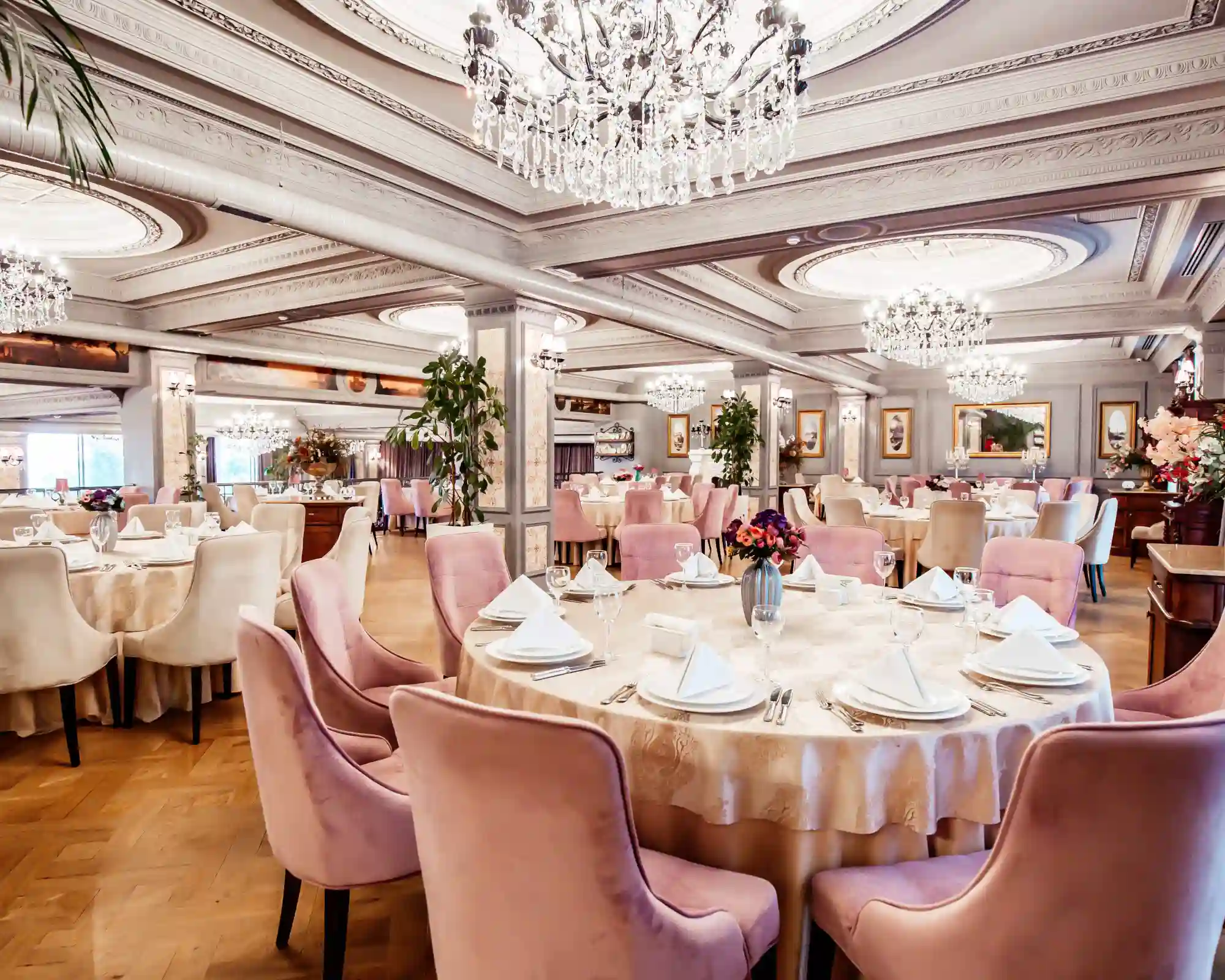 white covered round table surrounded by white covered chairs