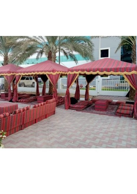 red majlis tent with carpet and cushions