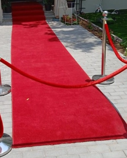red welcome carpet with stanchion