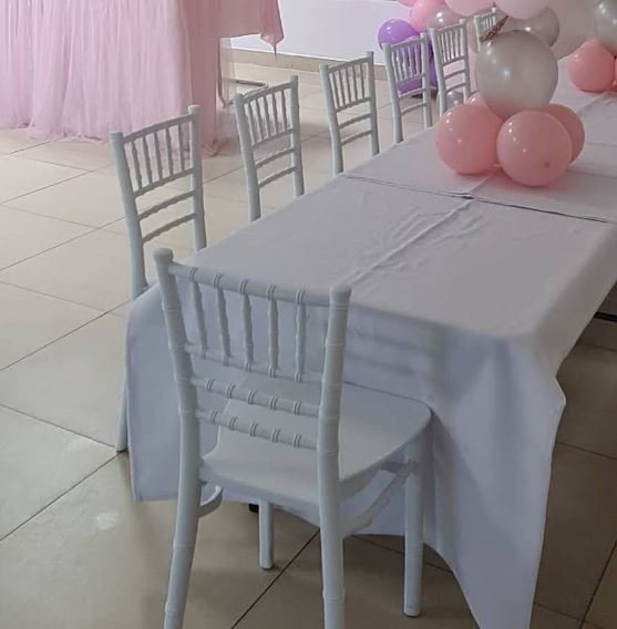 Colorful white chiavari kids chairs lined up in a kids birthday party for rent in Dubai