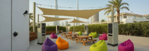 few picnic table and bench surrounded by green, orange, magenta, and purple colored bean bags