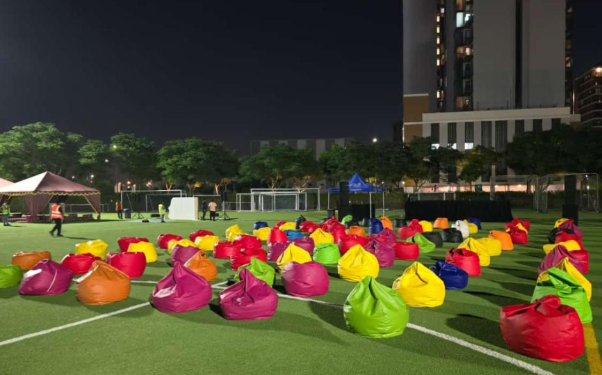 multi colored bean bags on a green floored ground
